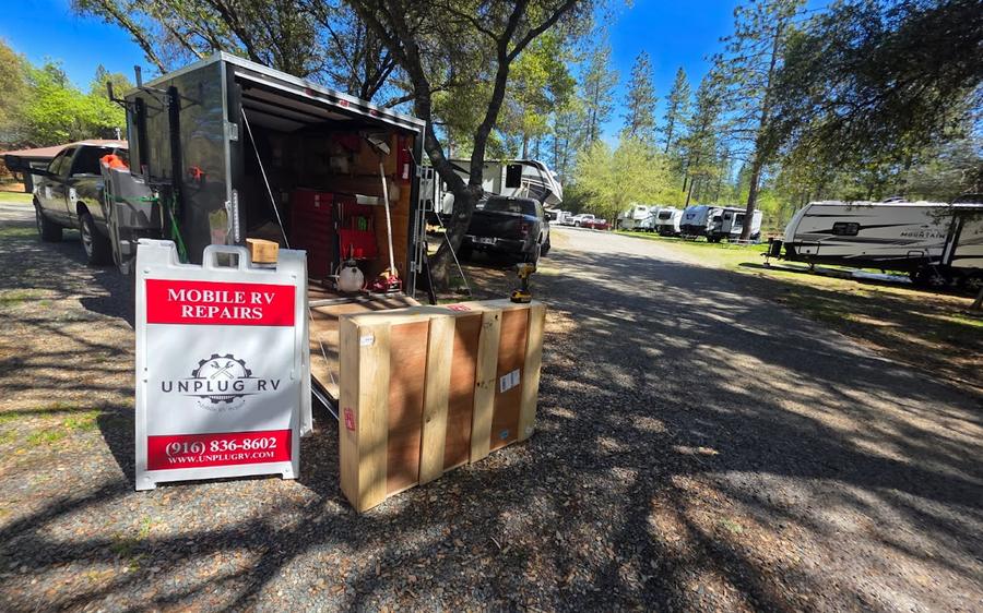 Unplug RV mobile service trailer set up at a customer's campsite