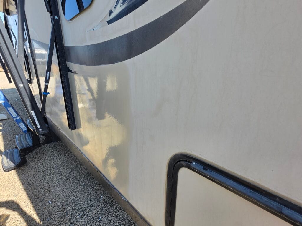 Before and after RV detailing — oxidized gel coat next to a freshly polished section