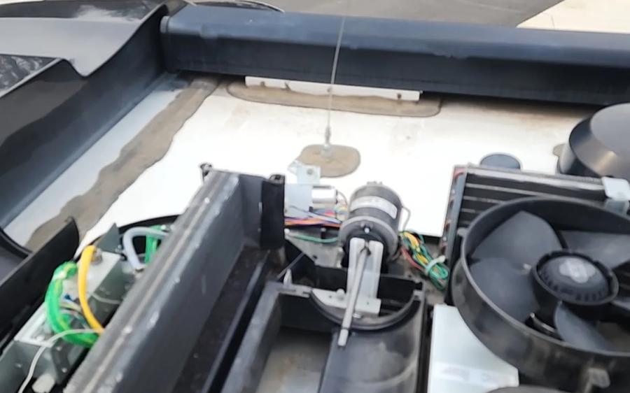 Rooftop A/C teardown at a campsite